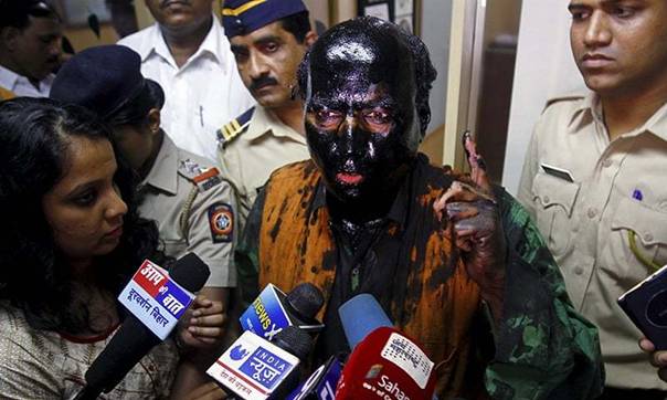 Sudheendra Kulkarni, chairman of the Observer Research Foundation Mumbai, with his face smeared with black ink, speaks to journalists in Mumbai, India, October 12, 2015. &mdash;Reuters