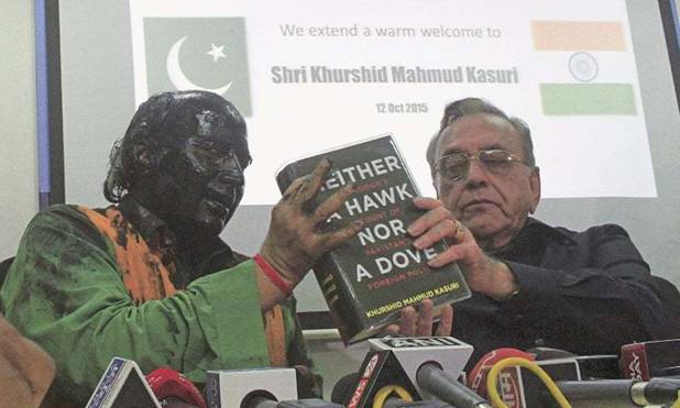 MUMBAI: Sudheendra Kulkarni, chairman of the Observer Research Foundation, Mumbai, his face smeared with black ink, holds a copy of the book by former foreign minister Khurshid Mahmud Kasuri &lsquo;Neither a Hawk Nor a Dove&rsquo; during a news conference here on Monday.&mdash;Reuters