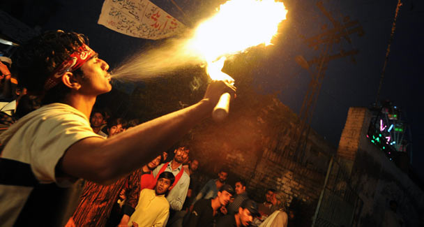 A devotee blows fire at the shrine. AFP 